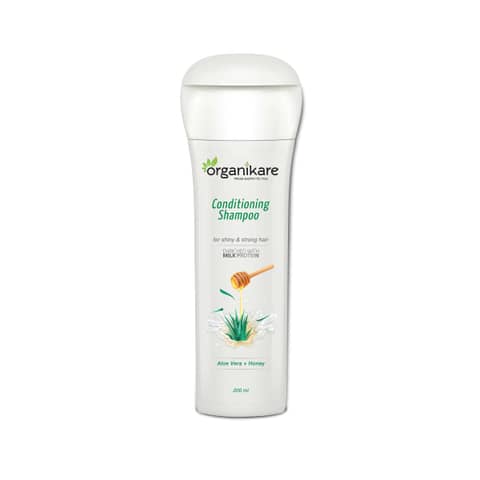 Organikare Conditioning Shampoo in a white pump bottle, featuring green botanical label details.