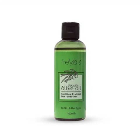 Freyias Olive Oil 100ml bottle, dark amber with white pump, standing upright against white background.