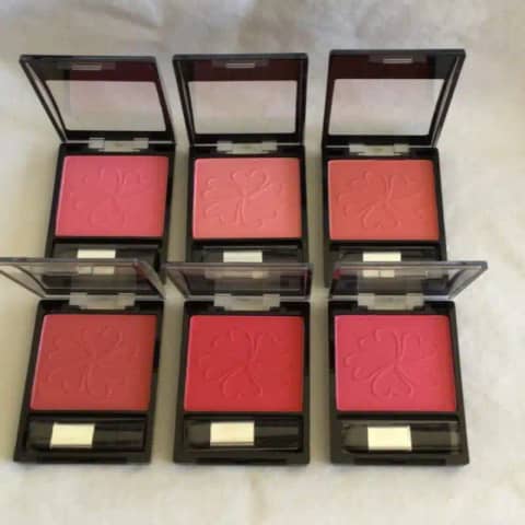 La Femme pressed powder blusher compact, open, revealing rosy pink shade and applicator brush.