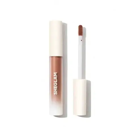 Sheglam Matte Liquid Lipstick in Vetiver, sleek black cap, clear tube showcasing its warm nude shade.