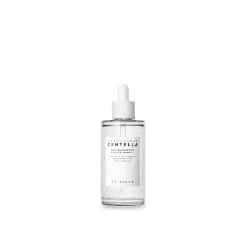 Skin1004 Madagascar Centella brightening ampoule, clear bottle with white dropper, showing suspended capsules.