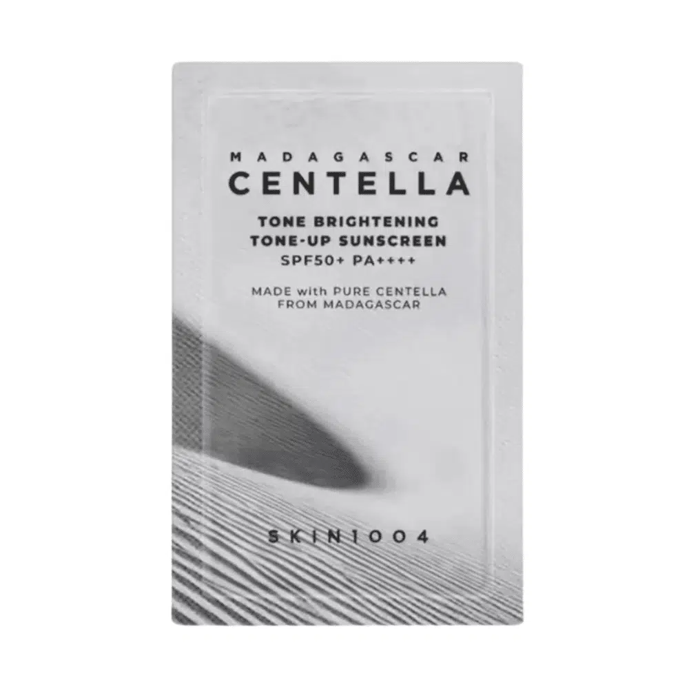 Front view of Skin1004 Tone Brightening Tone-Up Sunscreen 1.5ml sachet, white with green accents.