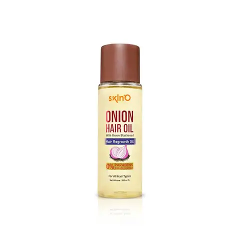 SkinO Onion Hair Regrowth Oil 100ml amber bottle standing upright, with natural green leaves.